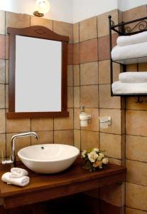 y baño con lavabo, espejo y toallas. en Dryas Guesthouse en Polydrossos