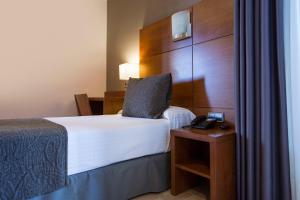 Postel nebo postele na pokoji v ubytování Hotel Via Augusta