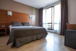 Postel nebo postele na pokoji v ubytování Hotel Via Augusta