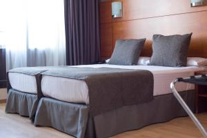 Postel nebo postele na pokoji v ubytování Hotel Via Augusta