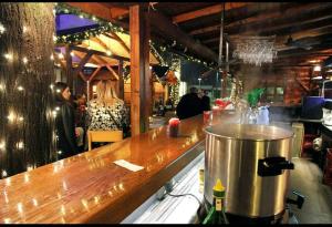 a bar in a restaurant with people standing behind a counter at AMAI Exclusive in Tuzla