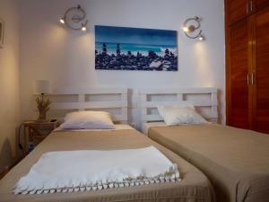 2 Betten in einem Zimmer mit Wandgemälde in der Unterkunft Apartamento Casita del Mar in Arrieta