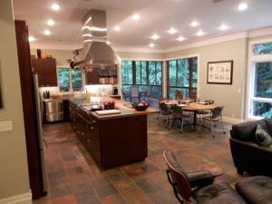 a large kitchen and dining room with a table and chairs at Pigeon Creek Inn - Adults Only in Holland