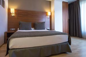 Postel nebo postele na pokoji v ubytování Hotel Via Augusta