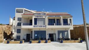 a large white building with a guest house at Le temps perdu in Oualidia +6 photos