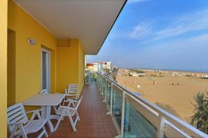 balcón con mesa y sillas y playa en Hotel Villa Olga, en Caorle