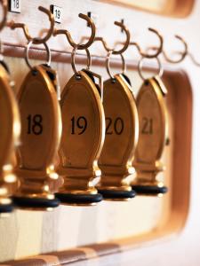 a row of gold clocks with numbers on them at Hotel Frederiksminde in Præstø