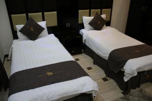 Una cama o camas en una habitación de Dorar Darea Serviced Apartments - Al Malqa