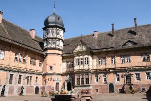 a large building with a clock tower in front of it at Ferienhaus am Solling in Dassel