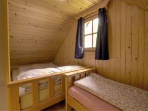 a bedroom with two bunk beds in a log cabin at Hiška vogar in Bohinj