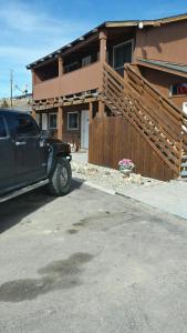 a black car parked in front of a house at Western Inn Motel & RV Park in Fairplay