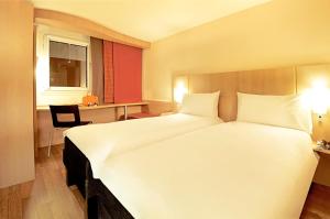Ένα ή περισσότερα κρεβάτια σε δωμάτιο στο ibis Santiago Providencia