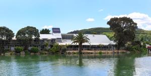a view of the hotel from across the lake at Tides Hotel in Nelson