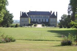 a large house with a large lawn in front of it at Domaine du Bourg Gites in Gannay-sur-Loire
