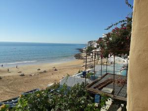 a view of a beach and the ocean at Playa Surf House in Taghazout
