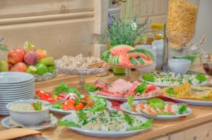 a table with many plates of food on it at Pensjonat Jastrzębia Turnia in Zakopane