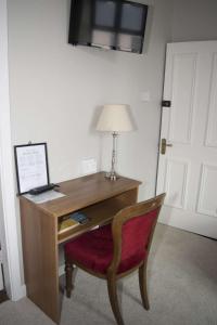 a wooden desk with a lamp on top of it at Ravine Hotel in Lisdoonvarna