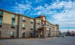 a hotel with a car parked in a parking lot at My Place Hotel-Altoona/Des Moines, IA in Altoona