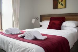 a bedroom with two towels on a bed at Ravine Hotel in Lisdoonvarna