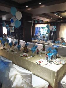 a long table with plates of food and balloons at Komitite Complex in Chuchuligovo