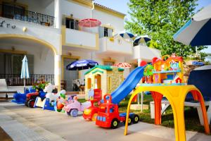a group of toys in front of a house at Marylin in Sidari
