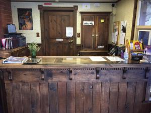 a bar in a restaurant with two wooden doors at Holiday Lodge in Grass Valley +2 photos