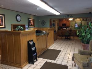 a large room with a bar in a restaurant at Interstate Inn in Roland