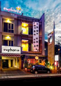 a building with a car parked in front of it at Euphoria Hotel in Legian