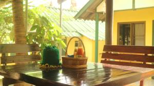 a wooden table with two baskets on top of it at Island Lodge in Ko Chang