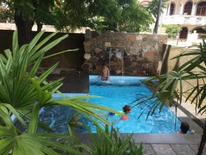 a pool with a man playing a game of basketball at Park Lane Apartments in Negombo