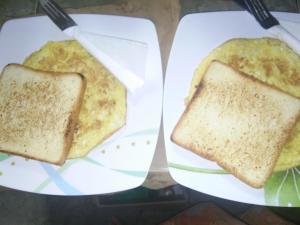 two slices of toast on white plates on a table at Sawe Homestay in Kuta Lombok