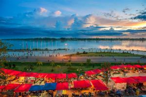 a group of red and blue tents and a body of water at Intouch Guest House in Vientiane