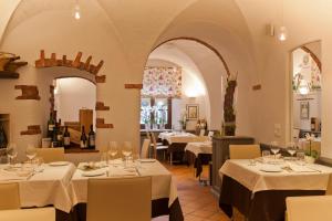 un ristorante con tavoli con tovaglie bianche di Albergo Ristorante La Palma a Bissone
