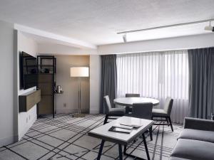 a living room with a table and chairs in a hotel room at Hyatt Regency Louisville in Louisville