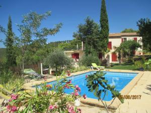 a swimming pool in front of a house at Villa Boulou in Rognes
