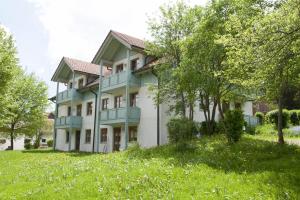 a large building with trees in front of it at Ferienwohnung "Woidliebe" in Lohberg