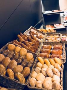 a display case filled with lots of different types of pastries at Hotel Astel in De Haan