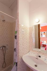 a bathroom with a sink and a shower curtain at Hostal Collsacabra in L’ Esquirol