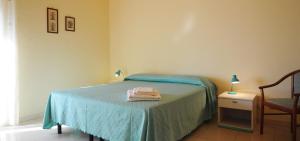 Postel nebo postele na pokoji v ubytování Albergo Villa Nobile