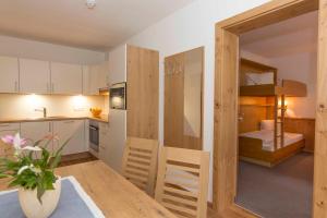 a small apartment with a kitchen and a bedroom at Hubergut Appartements in Radstadt +41 photos