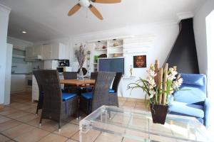 a dining room and kitchen with a table and chairs at Montemar in Roses