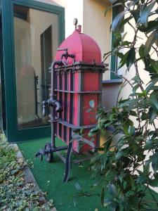 a toy fire hydrant sitting on the side of a house at Le Residenze dei Serravallo in Trieste