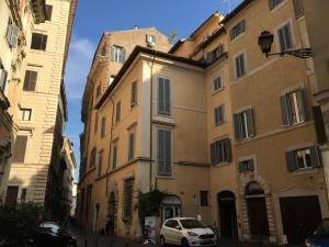 a white car parked in front of a building at M9 Pantheon Attic 11 in Rome