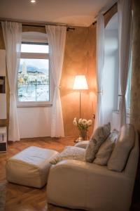 a living room with a white couch and a window at Apartment Sea View Obala Trumbića in Split