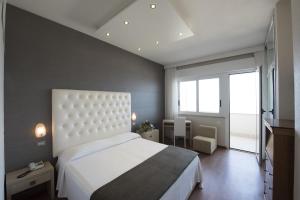 Postel nebo postele na pokoji v ubytování Hotel Benini