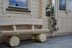 a wooden bench sitting outside of a building at Ferienhaus Holzhaisl in Kelheim