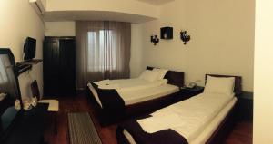 Un pat sau paturi într-o cameră la Hotel Casa Vlahilor