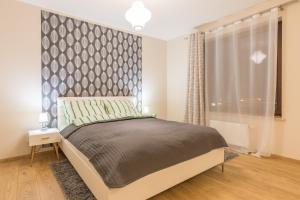 
Łóżko lub łóżka w pokoju w obiekcie Apartment Kremer VI Cracow
