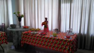 a table with a red and white table cloth with drinks on it at Jalapão Hotel in Palmas