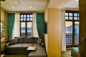 a living room with a couch and two windows at Hotel Momento Golden Horn in Istanbul